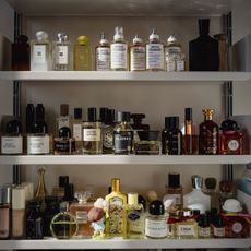 A sunny shelf with lots of perfumes on