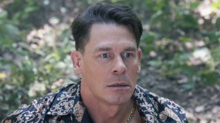 Chris sitting on ground looking stressed in Peacemaker Season 2