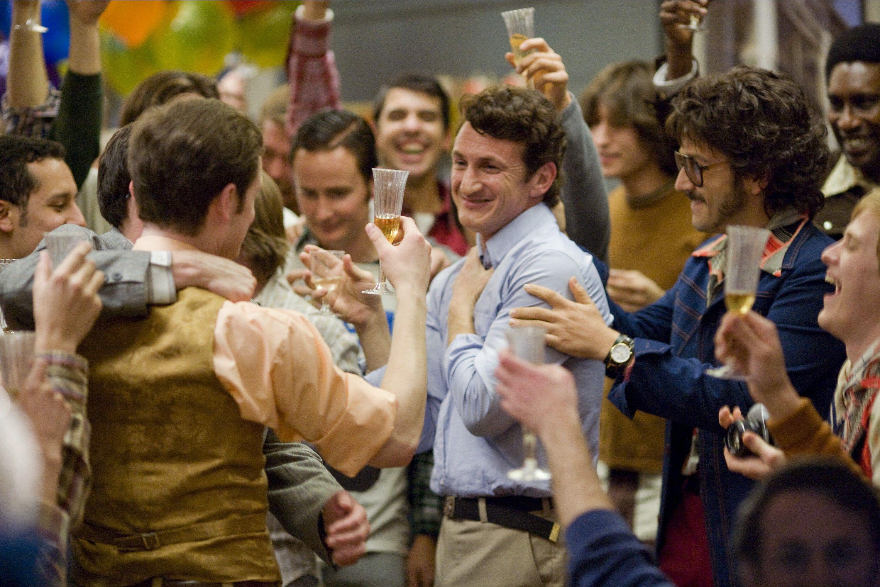 sean penn as harvey milk being celebrated by a crowd of men in the movie milk