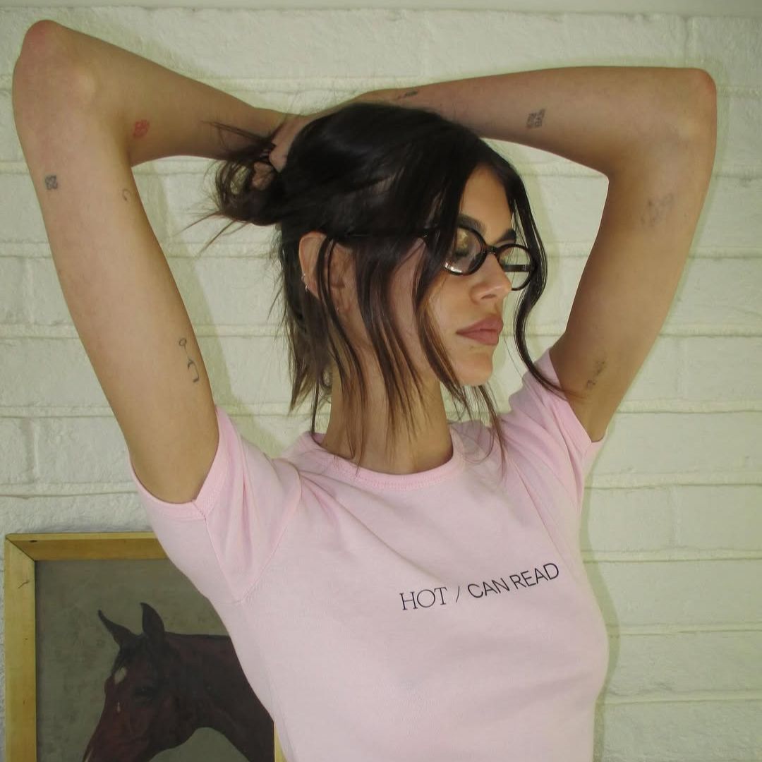 An image of @kaiagerber with tied-up hair and glasses