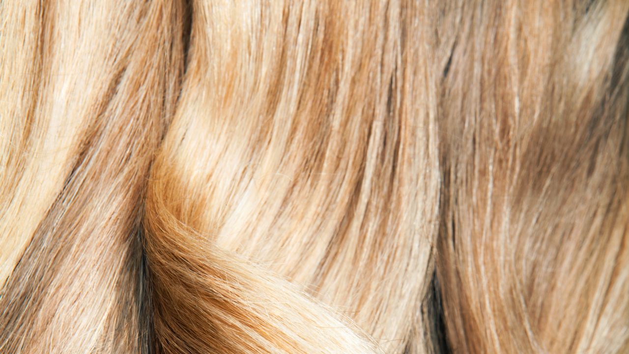  Close up shot of wavy, blond hair. - stock photo