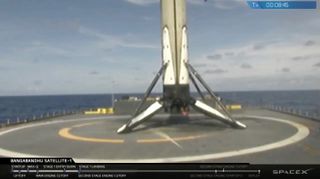 The first stage of SpaceX's first Block 5 Falcon 9 rocket sits on the deck of the drone ship "Of Course I Still Love You" just after acing its landing on May 11, 2018.