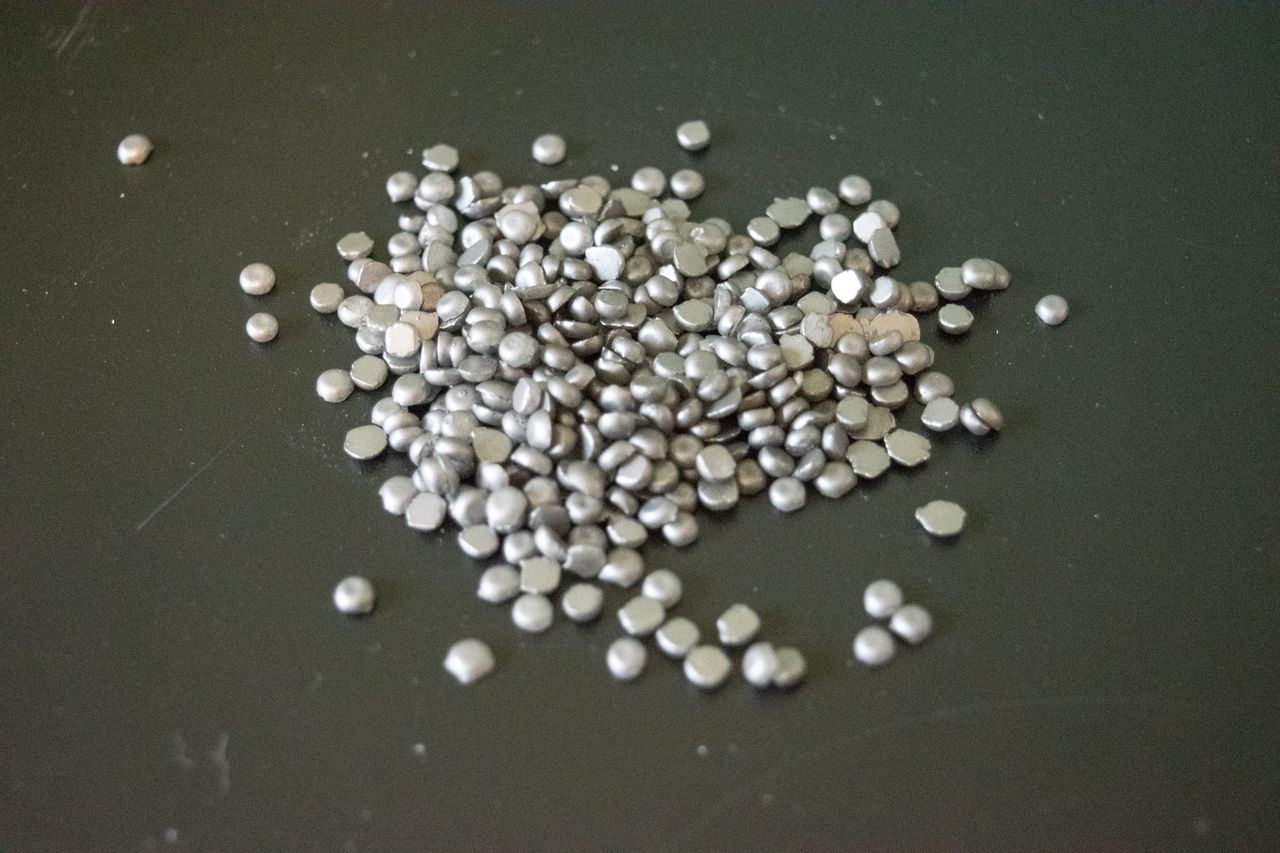Silca Super Secret chain wax pellets on a metal worktop