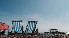 two deckchairs on a beach, showing one of 32 ways to stay fit and healthy on holiday