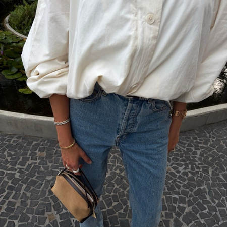An image of a woman wearing summer to fall transitional denim outfit idea 2026