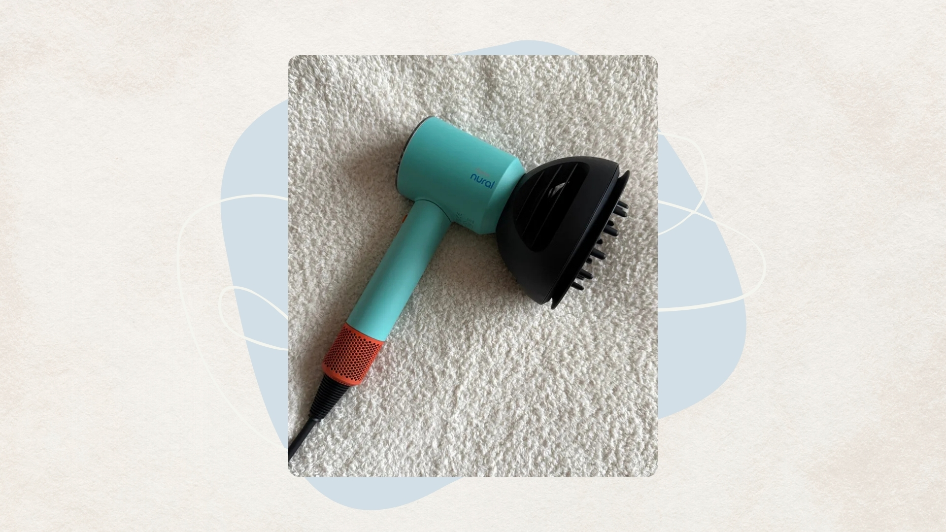 Image of teal and orange Dyson Supersonic Nural hair dryer on a beige background with blue detail and cream swirl