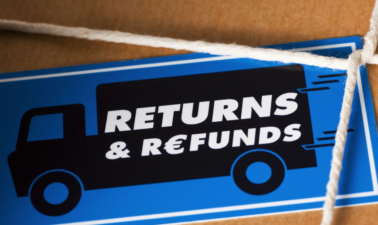 Illustration of a black van with the words Returns &amp; Refunds written across its side, against a blue background