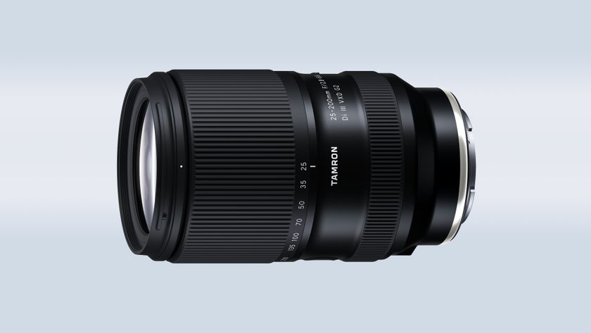 The Tamron 25-200mm f/2.8-5.6 Di III VXD G2 on a blue and gray background
