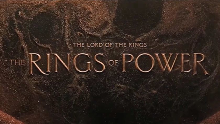 A sandy background with the words &quot;The Lord of the Rings: The Rings of Power&quot; over it.