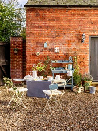 matalan table and chairs on gravel for budget patio ideas