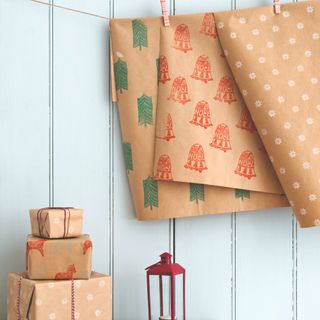 Wrapped Christmas presents and hanging printed giftwrapping paper