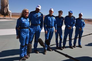 Laura Shepard Churchley joins her New Shepard 19 crewmates, including "Good Morning America" co-anchor Michael Strahan (to her left), to answer reporters' questions at the landing pad where their booster returned to Earth on Dec. 11, 2021.