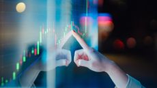 A hand touching a screen upon which a visualization of data is displayed in a red and green box chart. It represents data-driven decision-making, with the person touching the screen deriving value from the graph.