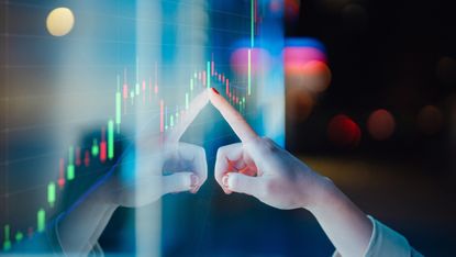 A hand touching a screen upon which a visualization of data is displayed in a red and green box chart. It represents data-driven decision-making, with the person touching the screen deriving value from the graph.