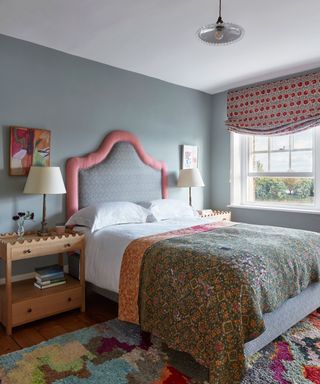 Colorful bedroom with large bed and patterned divan