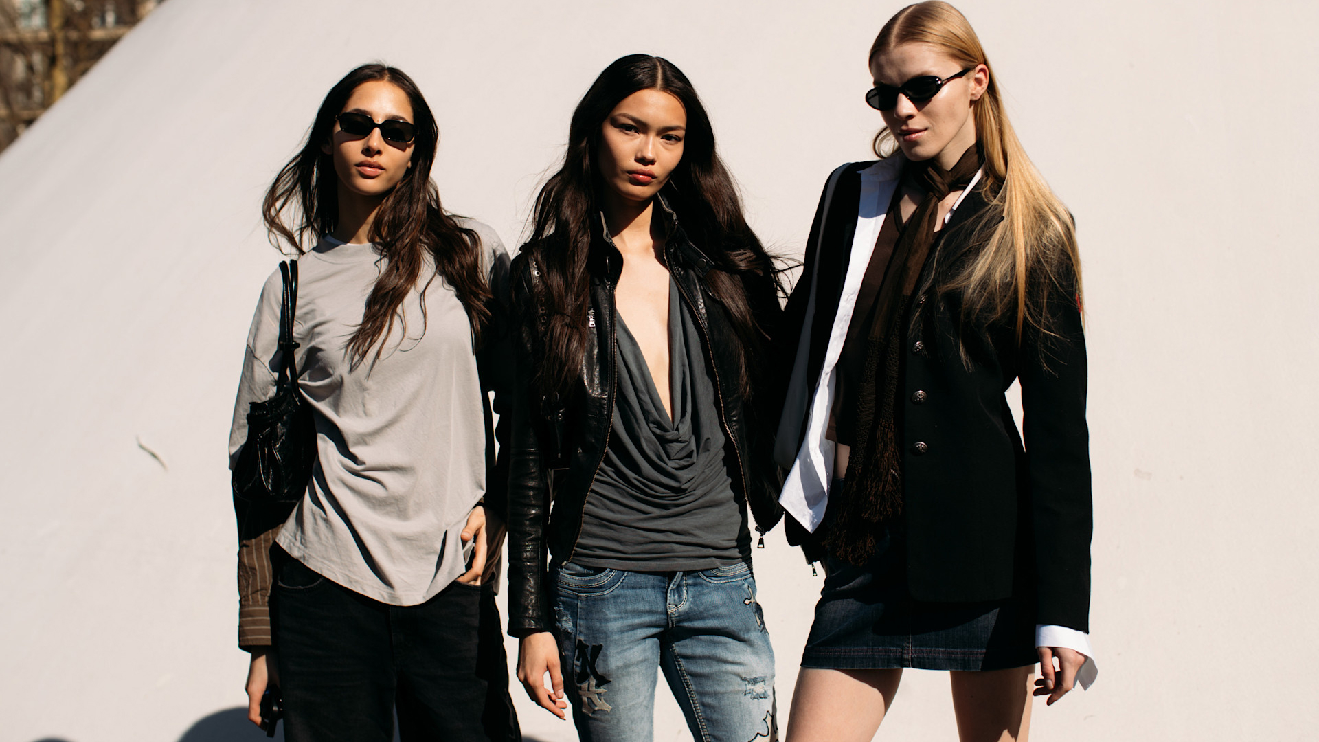 Attendees at paris fashion week fall 2025 standing in front of beige wall