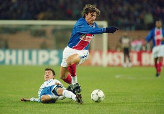 Paris Saint-Germain player David Ginola is tackled during a UEFA Champions League group stage match against Dynamo Kiev on October 19, 1995 in Kiev, Ukraine.