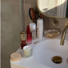 Beauty products on edge of sink