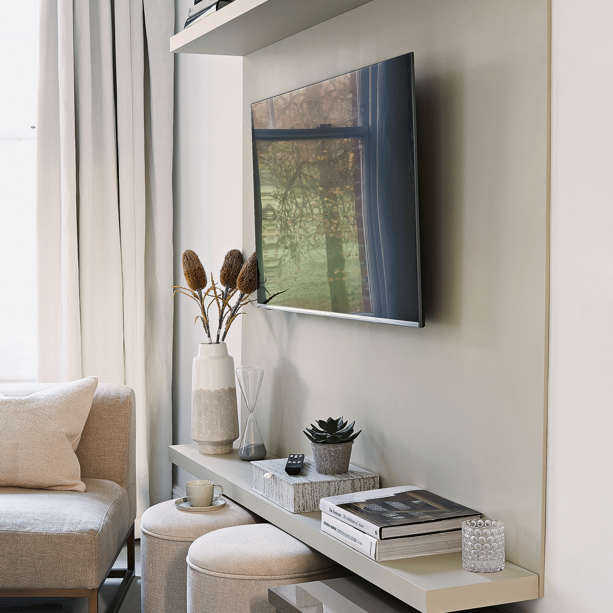TV mounted on a grey living room wall