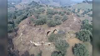 An aerial view shows the Roman-era arena poking out of a hilly area in Mastaura, Turkey.