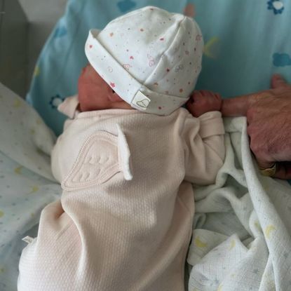 Princess Eugenie's daughter in a pink sleeper