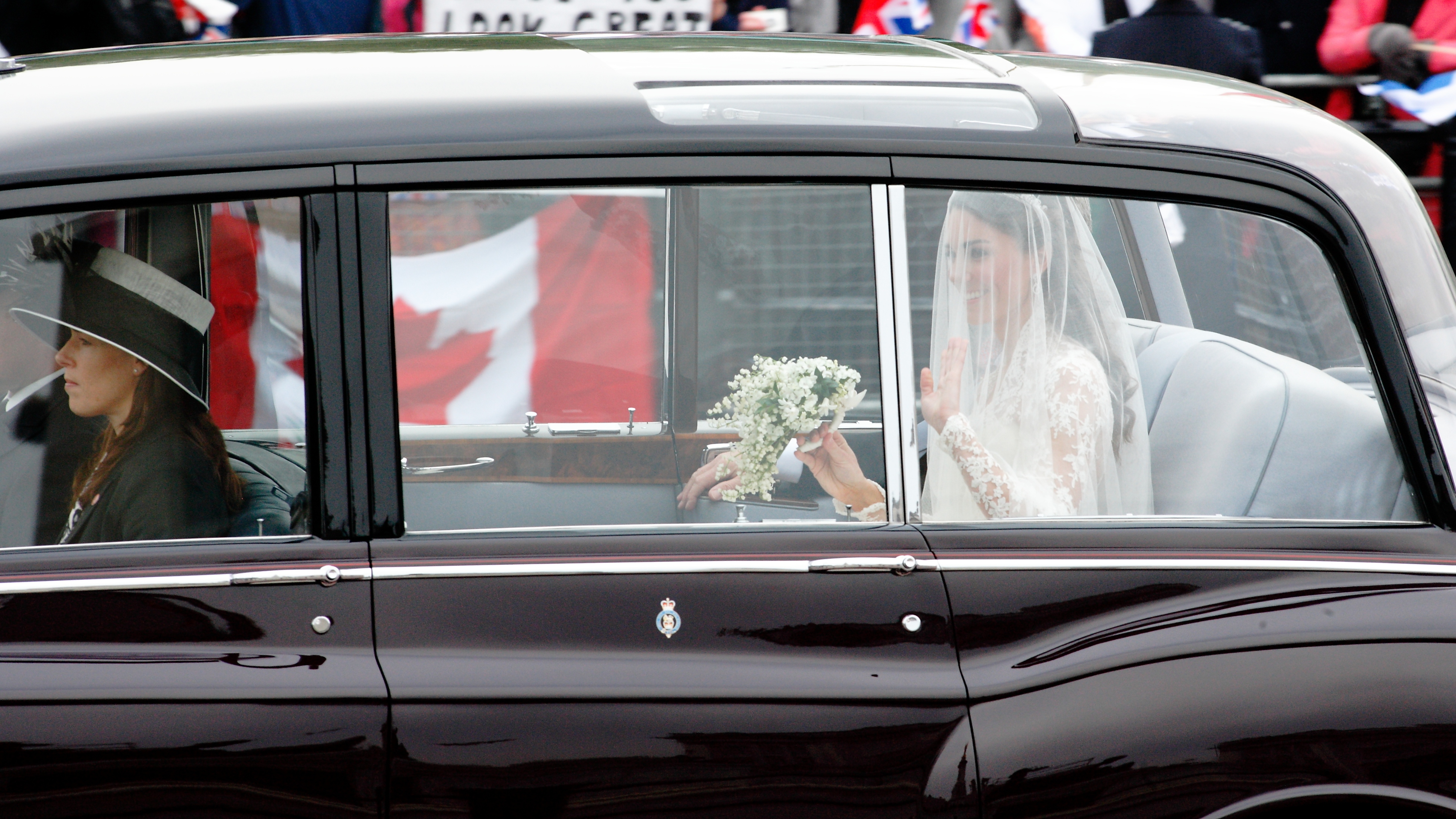 Kate Middleton waves to the crowd as she travels by car along the Mall to Westminster Abbey 29th April 2011
