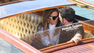 Jennifer Lopez and Ben Affleck sit intimately close on a water taxi in Venice.