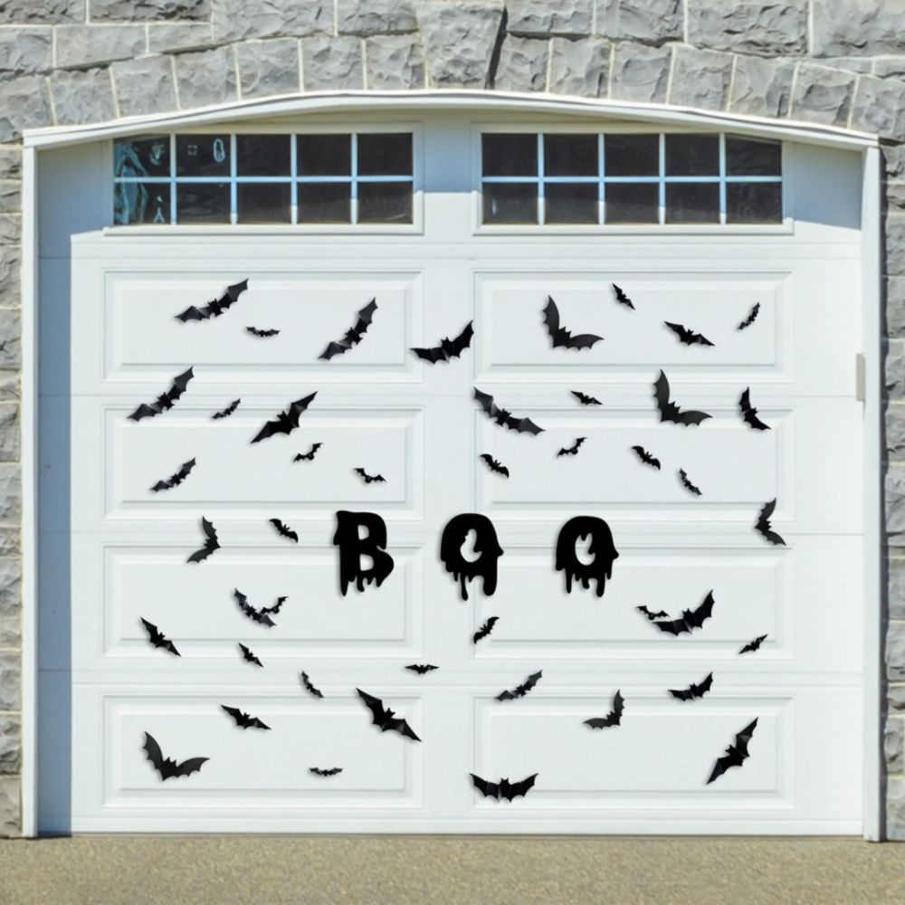 bat and boo Halloween magnets on a garage door