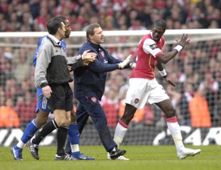 Arsenal's Emmanuel Adebayor was one of three players sent off following a last-minute fracas in Cardiff.