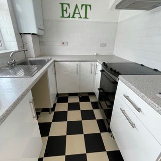 before shot of a white kitchen with chequerboard tiles