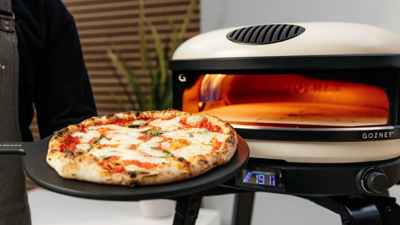 The Gozney Arc Pizza Oven, lit and being used to cook
