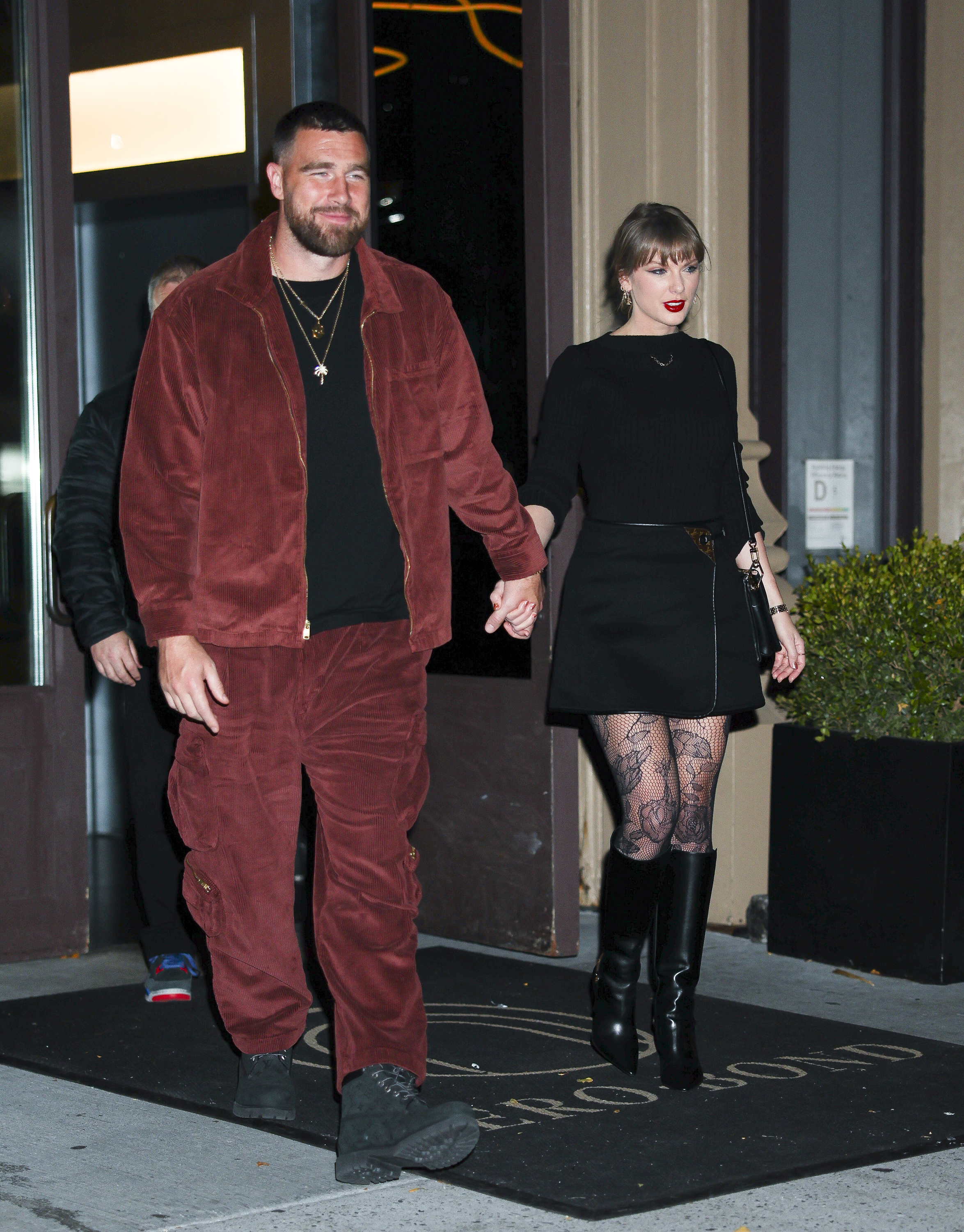 Taylor Swift wearing black knee-high boots with Travis Kelce in New York City