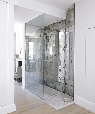 A shower enclosure with antique mirrored walls
