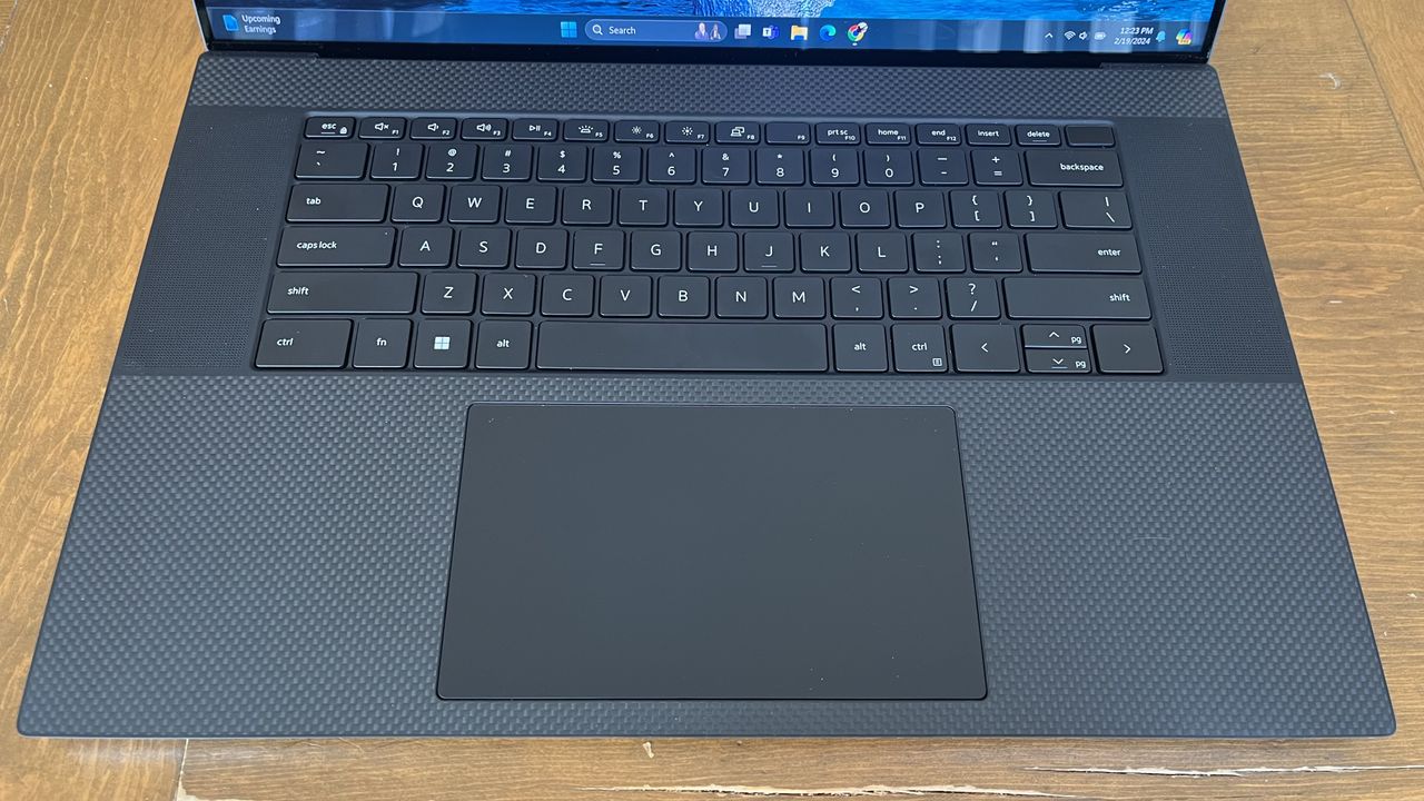 Dell XPS 17 laptop in use on a wooden desk