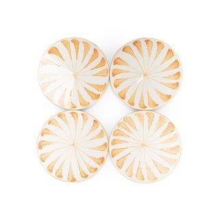 4 white ceramic round plates with orange-like pattern
