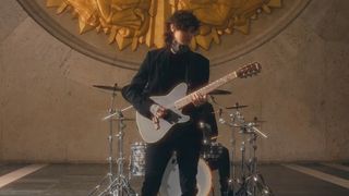 Tim Henson playing in Polyphia's Playing God music video