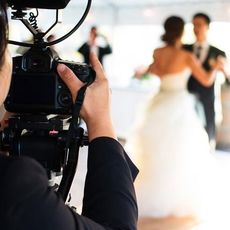 Dress, Video camera, Camera, Photograph, Bridal clothing, Cameras & optics, Television crew, Camera operator, Videographer, Strapless dress, 