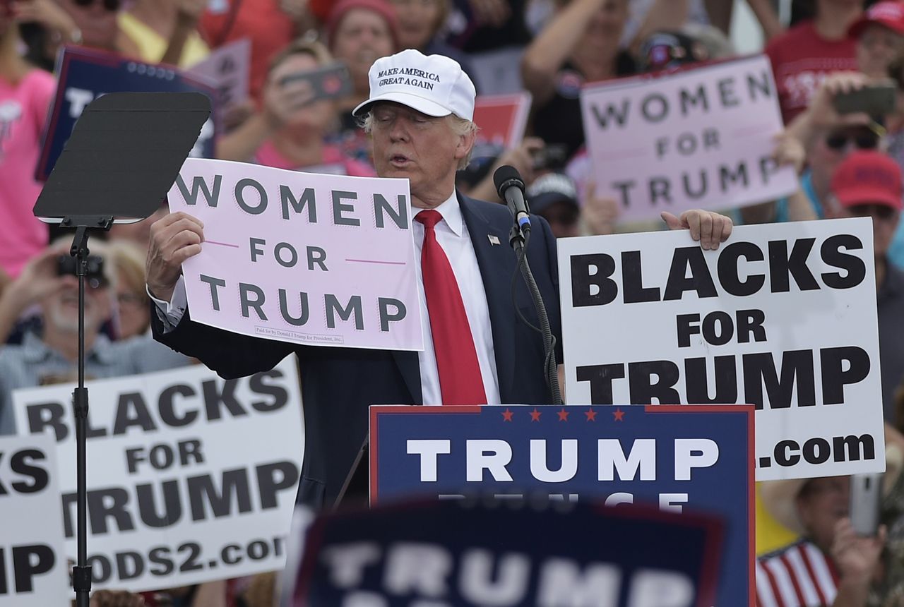 Donald Trump holds a &amp;#039;women for trump&amp;#039; sign in Florida