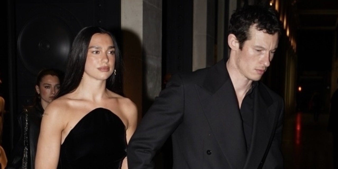 Dua Lipa and Callum Turner exude sophistication as they leave a restaurant hand-in-hand, heading to their hotel. Dua stuns in a strapless black velvet gown, while Callum complements her in a tailored double-breasted black suit, making a coordinated and stylish statement. on Jan. 28