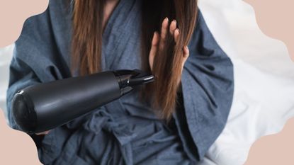 woman blow drying her hair at home, used to illustrate an article on how to use a hair dryer without drying your hair