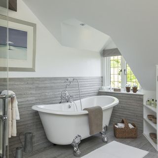 bathroom with grey wooden flooring and photoframe on white wall