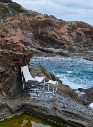 White outdoor furniture on cliffs, photographed by Massimo Vitali for Wallpaper*