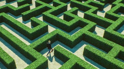 Man walking through a complicated maze.