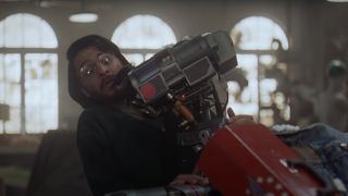 Fisher Stevens is awkwardly hugged by Johnny 5 in Short Circuit 2.
