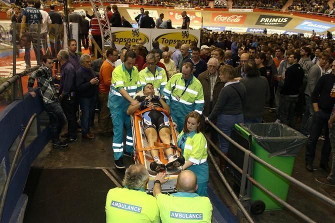 Roberts being escorted from the track