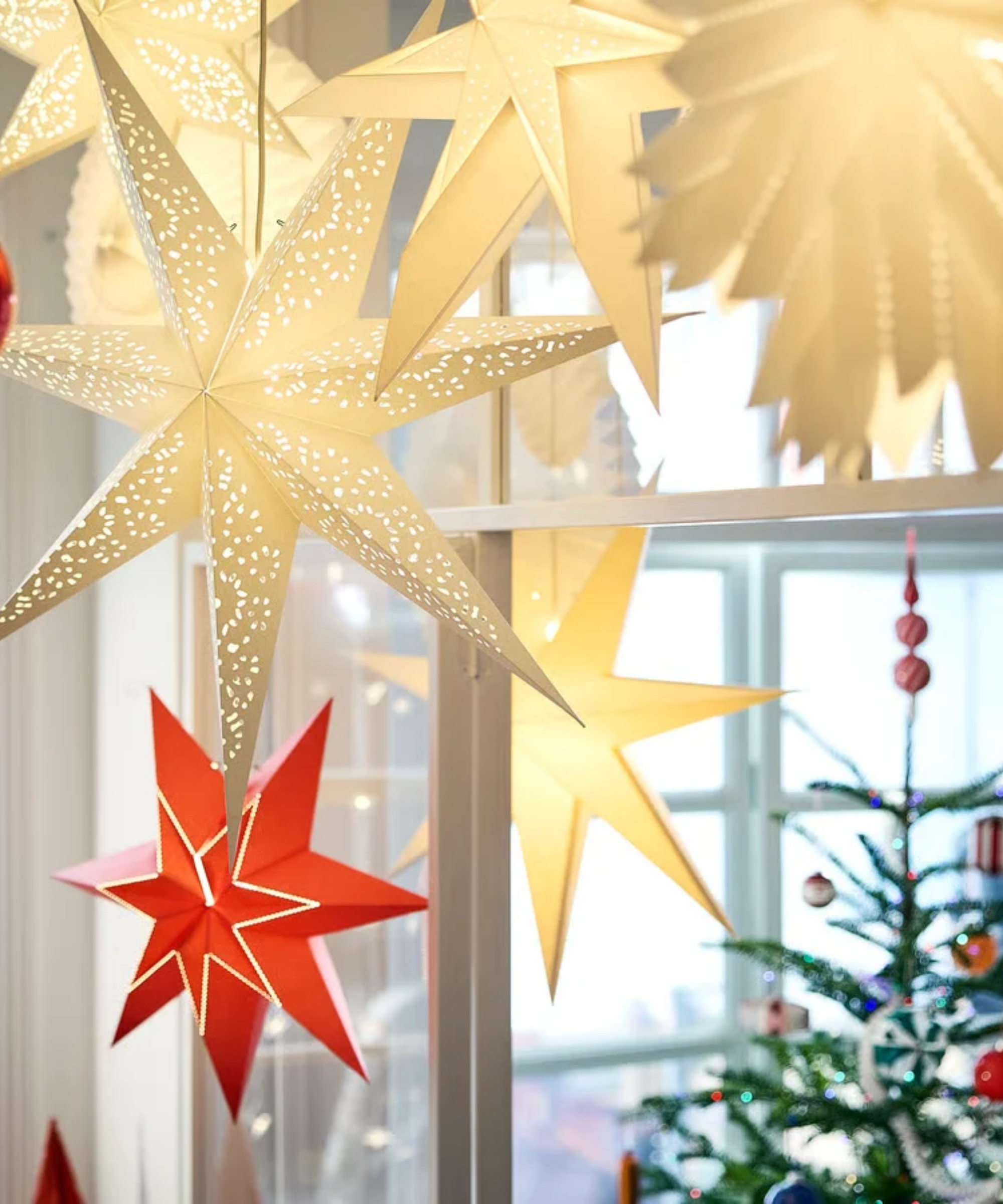 IKEA star-shaped Strala lantern lights hanging overhead a minimalist holiday living room area