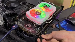 An AMD Radeon RX 580 attached to an RX 5070 Ti be a series of wires, bypassing the hole in the Nvidia card's PCB