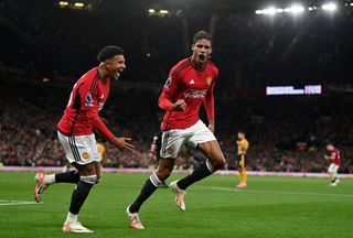 Tottenham vs Manchester United live stream Raphael Varane of Manchester United celebrates with Jadon Sancho after scoring the team's first goal during the Premier League match between Manchester United and Wolverhampton Wanderers at Old Trafford on August 14, 2023 in Manchester, England. (Photo by Gareth Copley/Getty Images)