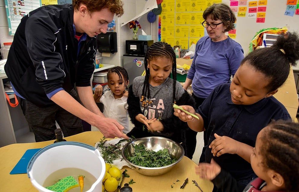 Making a salad at the Thursday evening reading program.