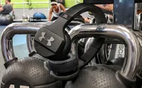 The JBL Under Armour Sport Wireless Train hanging from weights